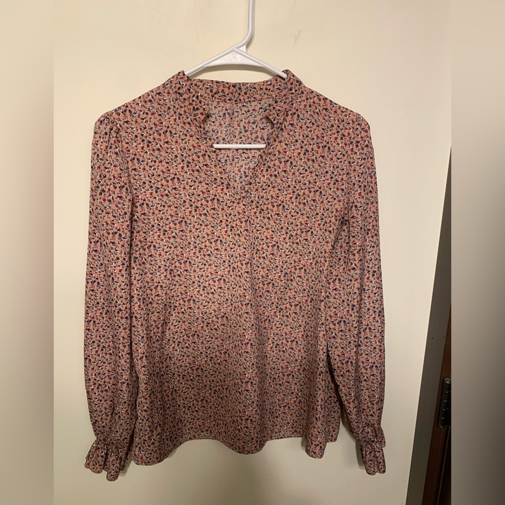 Floral blouse. Cuffed wrists. Pink with floral design.